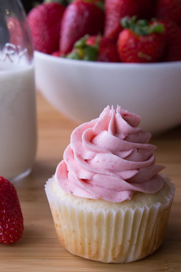 Vanilla Cupcakes with Strawberry Buttercream. Light, fluffy, super moist vanilla cupcakes topped with creamy strawberry buttercream made from fresh berries. These are cupcake perfection!