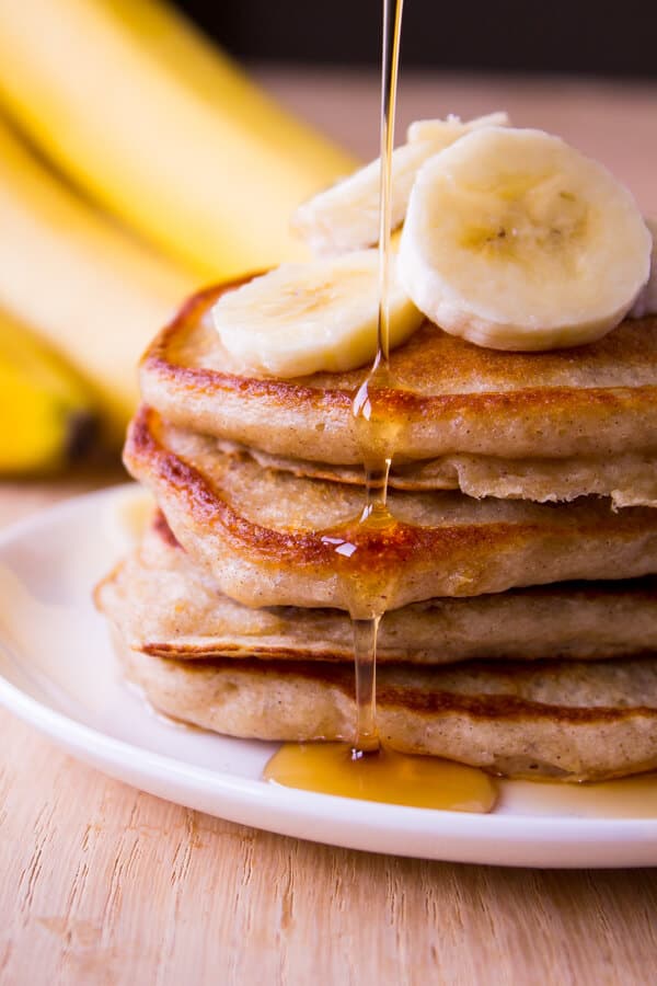 Light & Fluffy Banana Pancakes. These are like banana bread in pancake form. Super moist, filled with vanilla & cinnamon flavor - Start your morning with this easy recipe! www.justsotasty.com