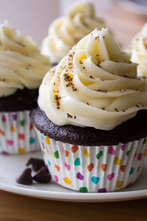 Chocolate Cupcakes with Cream Cheese Frosting. The perfect chocolate cupcakes are made even better by frosting them with thick & creamy cream cheese buttercream! www.justsotasty.com
