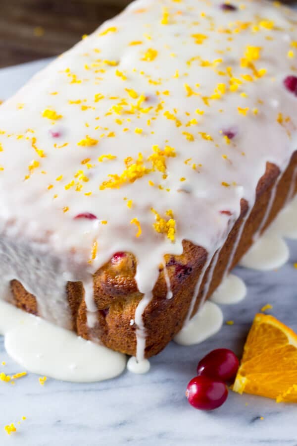 Glazed Cranberry Orange Loaf. Super soft & moist because it's made with sour cream - be sure to include this recipe in your holiday baking check list! www.justsotasty.com