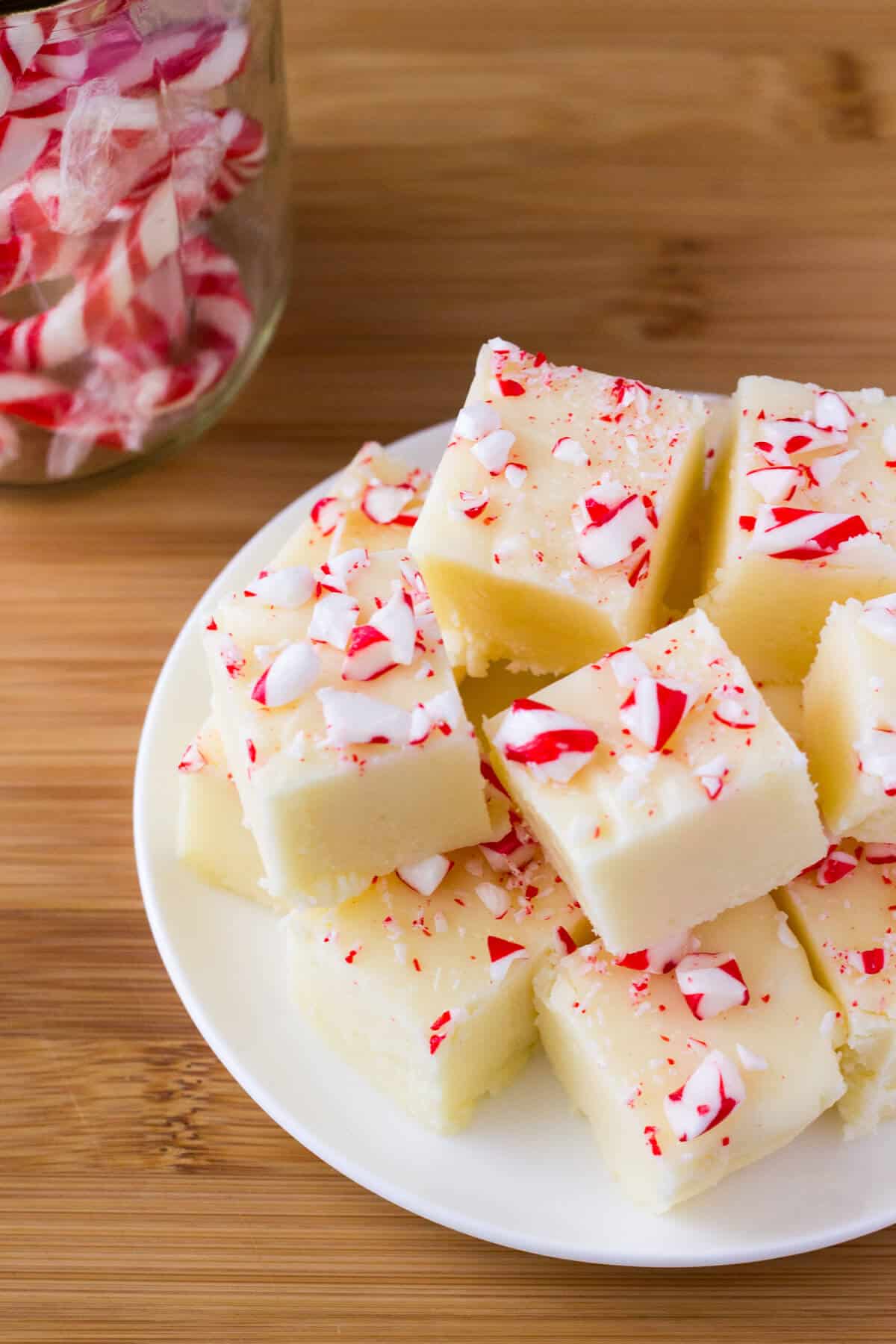 Creamy White Chocolate Peppermint Fudge. So delicious & perfect for the holidays - it makes a decadent, delicious gift! www.justsotasty.com