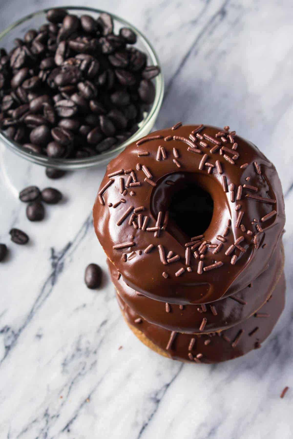 A delicious, coffee-flavored cake doughnut dipped in fudgy, chocolate glaze. These super easy Baked Mocha Doughnuts are the best way to get your morning caffeine fix! www.justsotasty.com