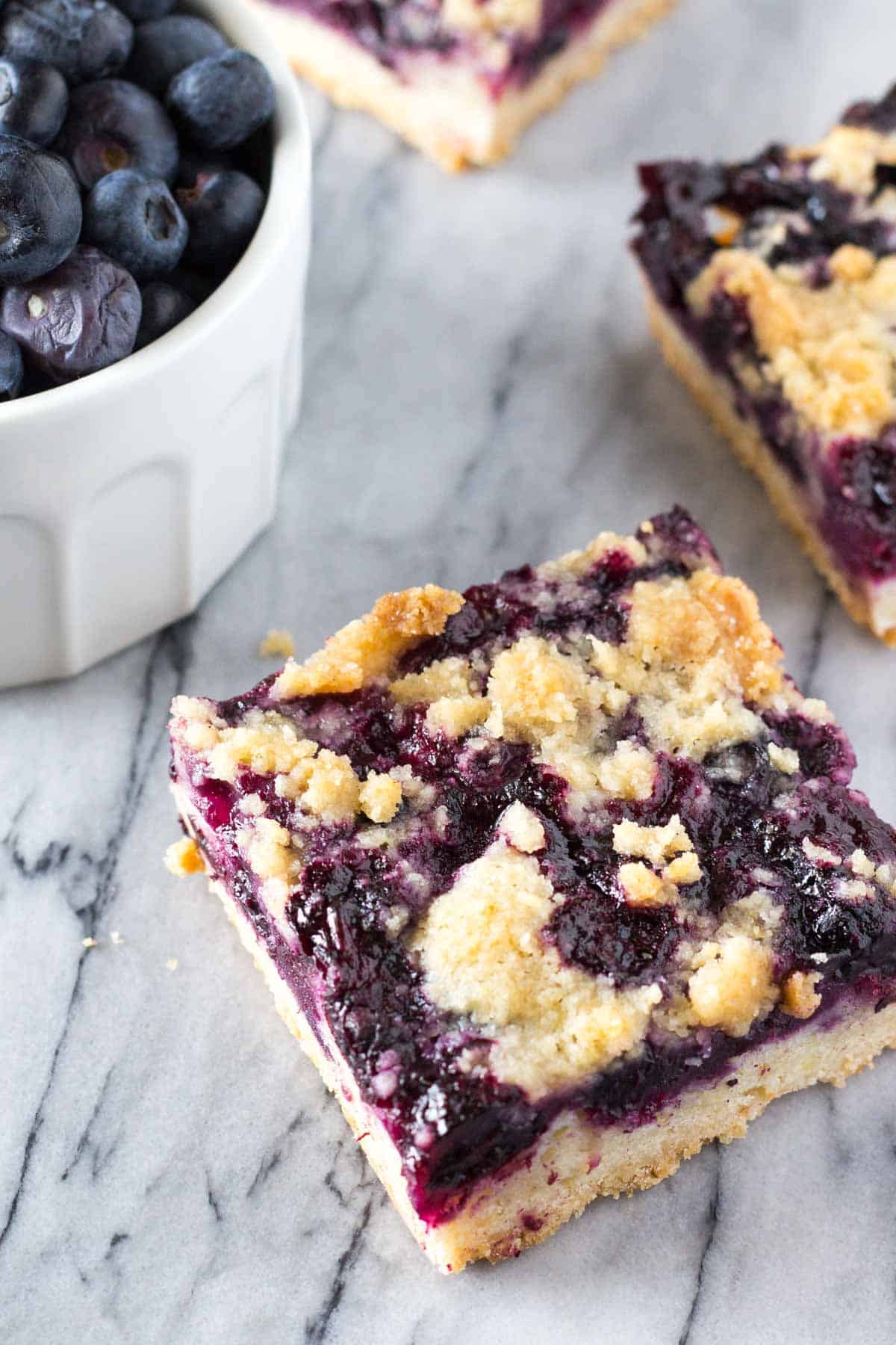 A buttery shortbread-like base, juicy blueberry filling & crumbly crumble topping - these Blueberry Crumble Bars are so easy & delicious!