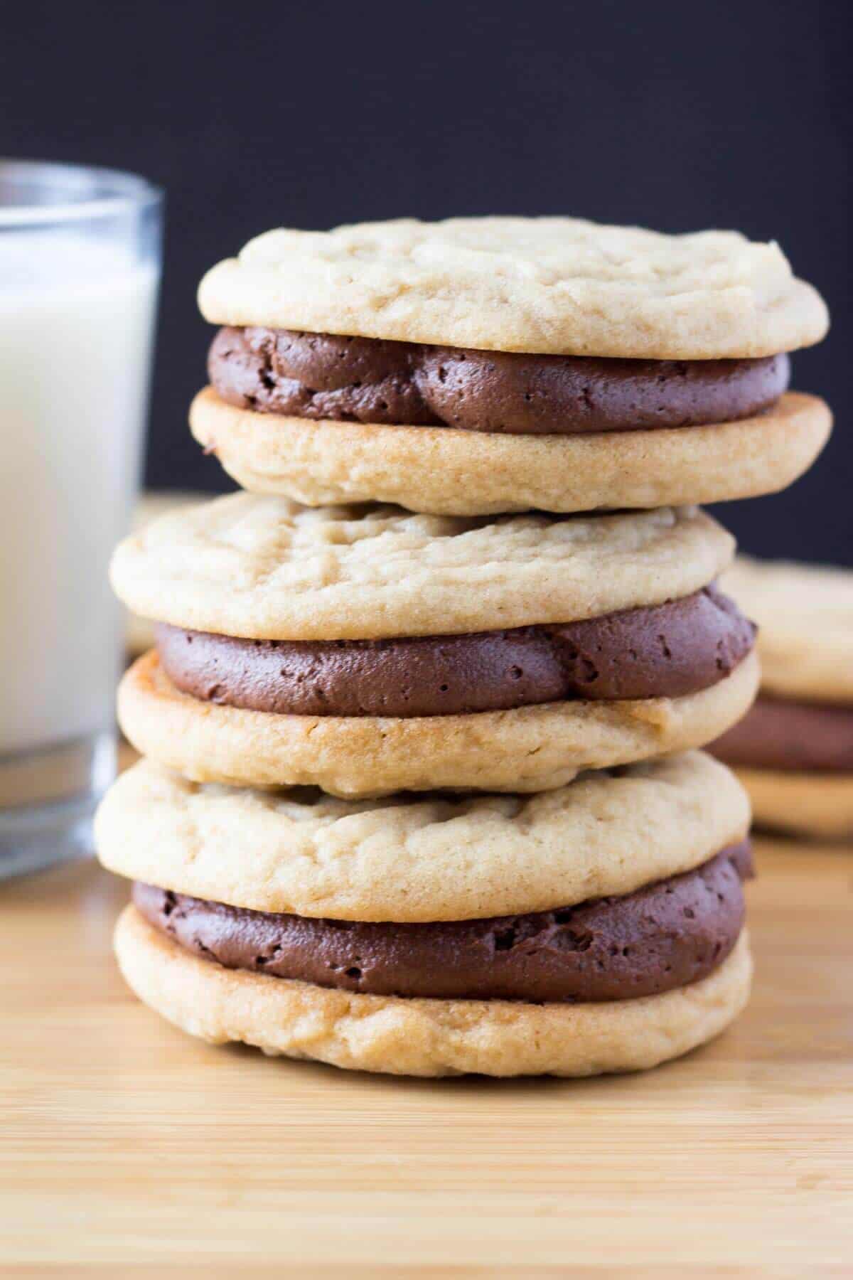 Two soft & chewy cookies slathered with milk chocolate buttercream. If you like peanut butter cups - these Peanut Butter Sandwich Cookies with Chocolate Frosting are for you. 