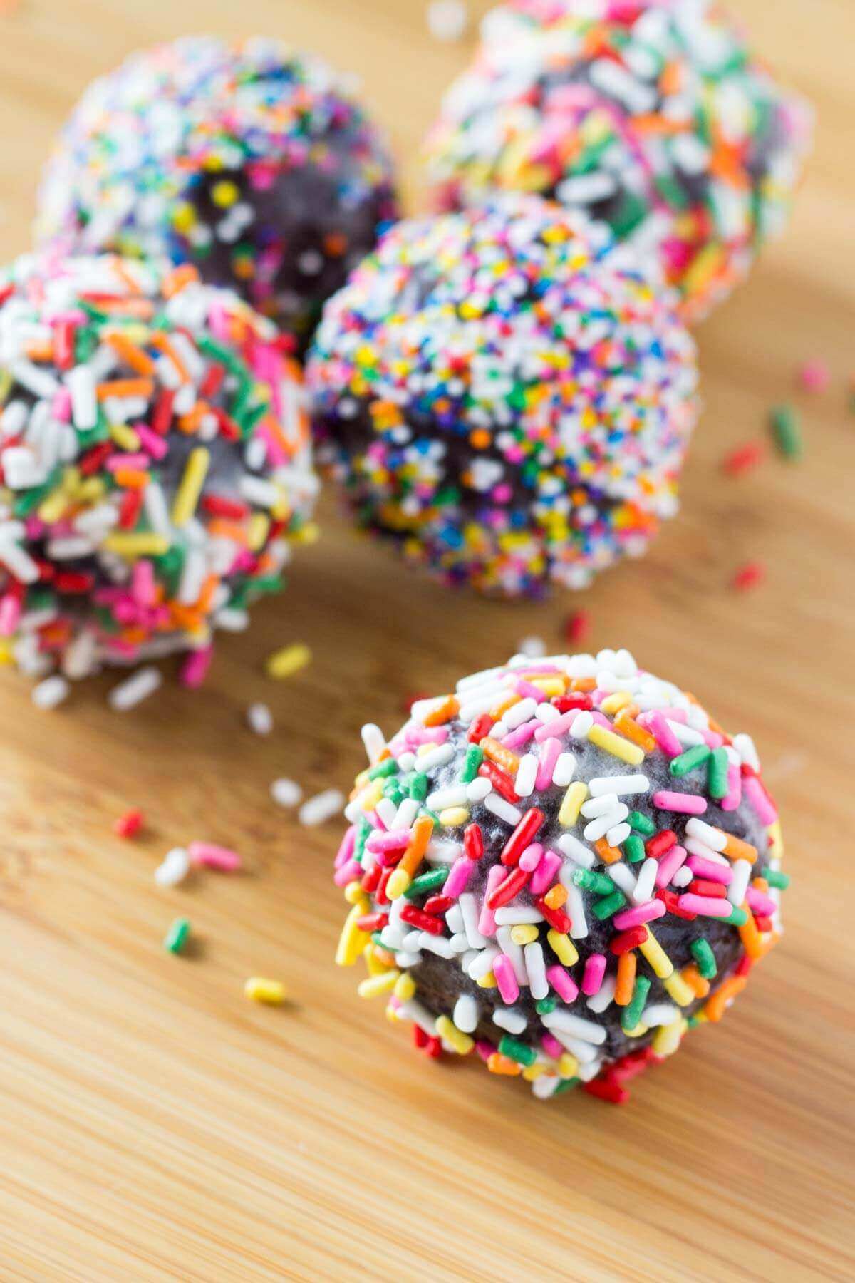 Perfectly fudgy Chocolate Doughnut Holes dipped in sweet vanilla glaze! Fluffy, oh so moist & so much better than the doughnut shop! www.justsotasty.com