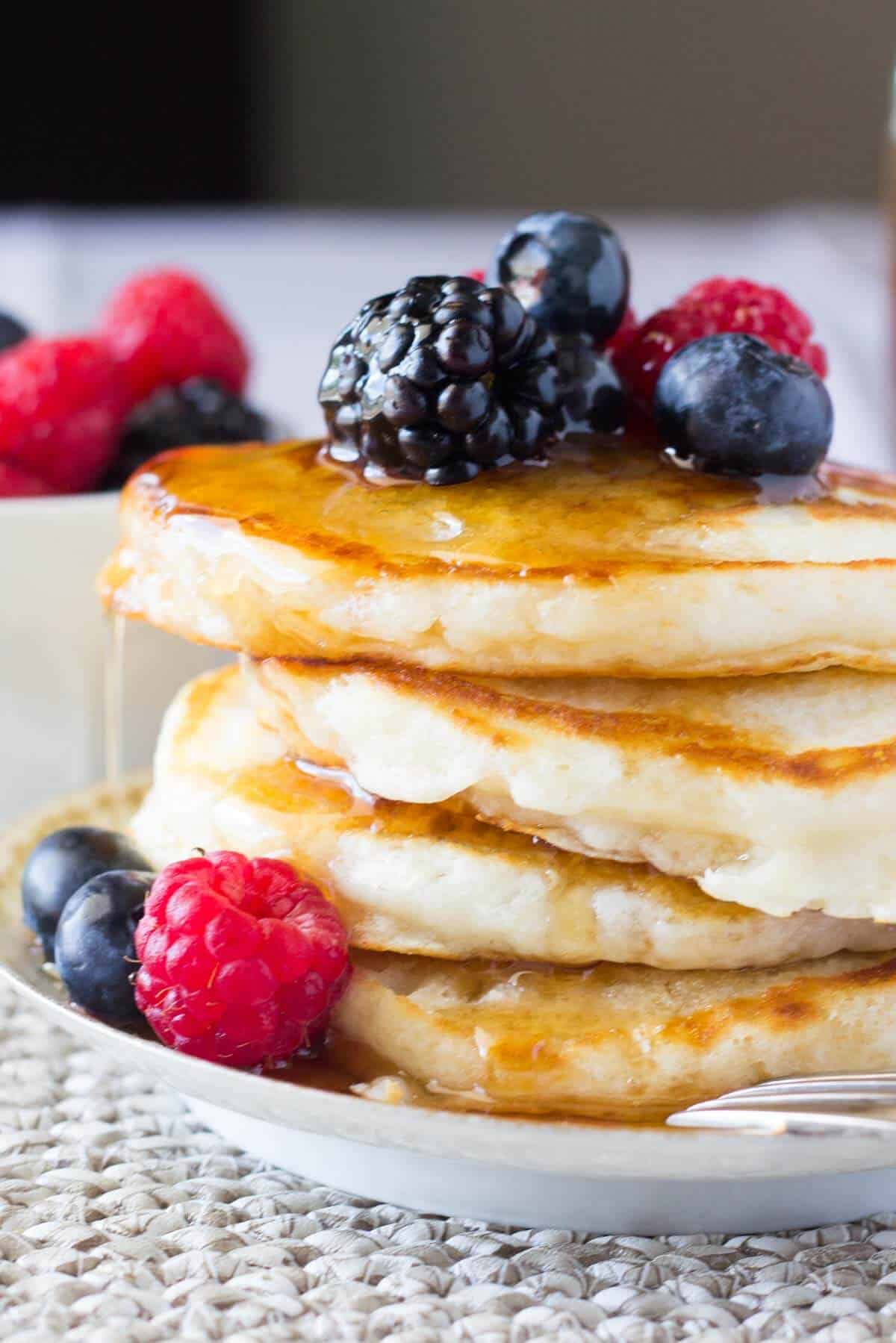 The softest, most fluffy Buttermilk Pancakes imaginable. Perfectly golden edges & designed for soaking up lots of maple syrup - these are the BEST pancakes you'll ever eat!