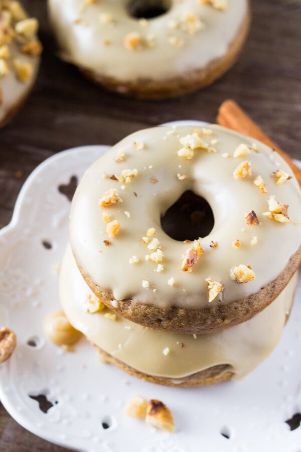 A delicious spice cake doughnut with sweet maple glaze and topped with crushed walnuts. It's like fall in maple doughnut form - and best of all, they're baked instead of fried!
