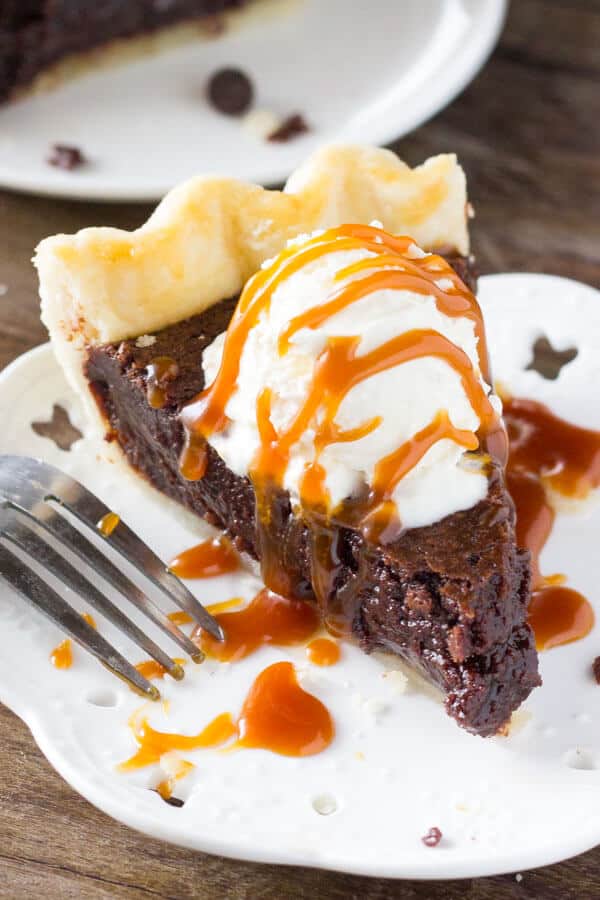 This easy, homemade Fudge Brownie Pie features a flaky, golden pie crust shell filled with the gooiest, fudgiest brownie. Serve it with ice cream & caramel sauce for the ultimate treat!