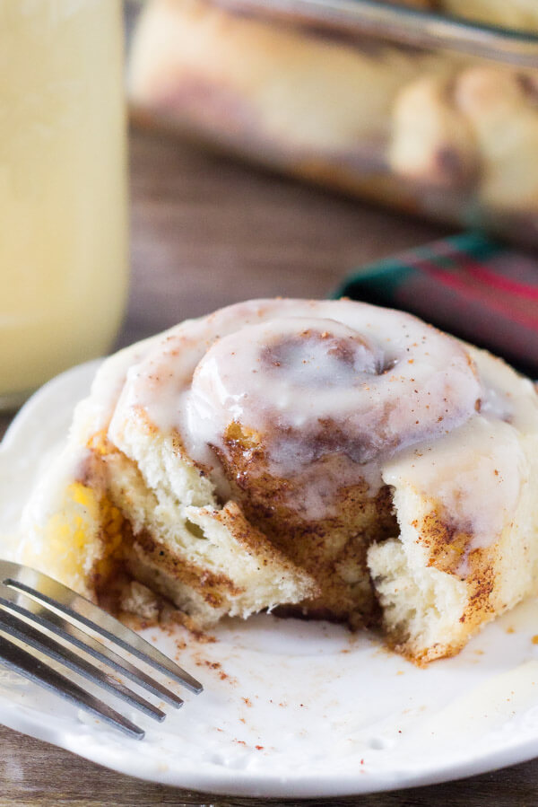 Eggnog Cinnamon Rolls. These super fluffy cinnamon buns are made with eggnog, filled with spices, and drizzled with eggnog glaze. Prepare the buns overnight, then wake up to cinnamon rolls! www.justsotasty.com