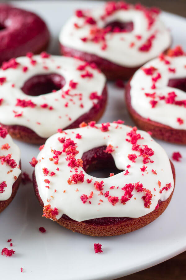 Baked Red Velvet Doughnuts. These moist doughnuts have the perfect cake doughnut crumb, a delicious red velvet flavor & a cream cheese glaze. www.justsotasty.com