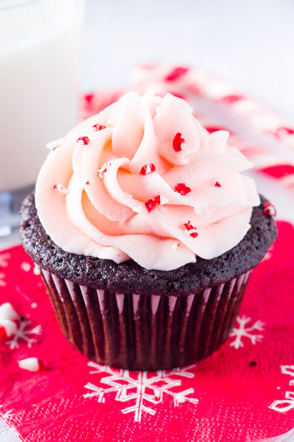 Candy Cane Chocolate Cupcakes. Super moist chocolate cupcake topped with peppermint buttercream and sprinkled with candy canes - the perfect holiday cupcake! www.justsotasty.com