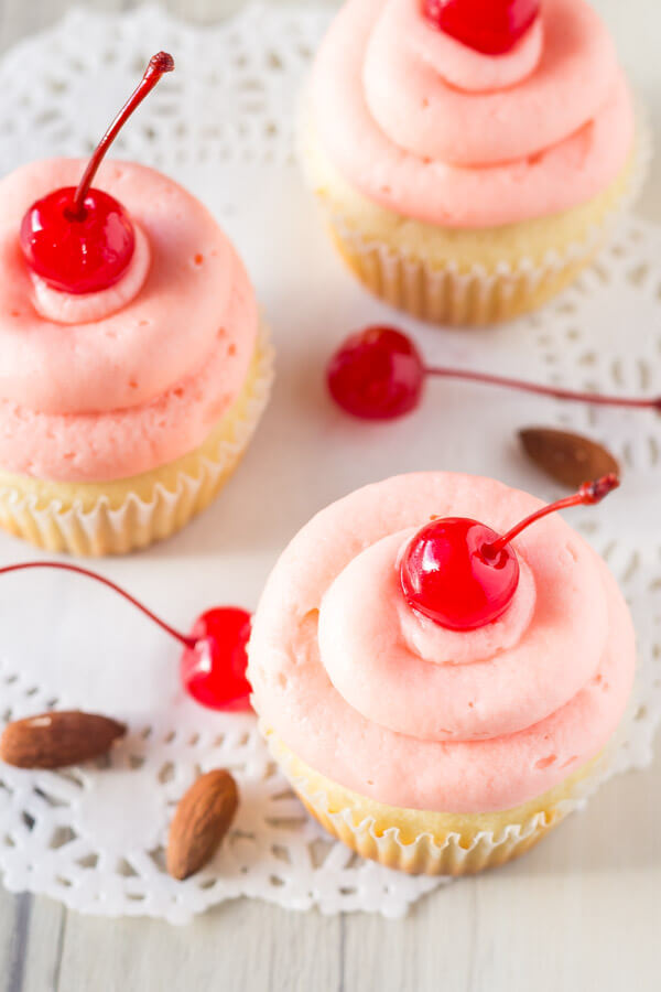 Cherry Almond Cupcakes. Fluffy, moist, super soft almond cupcakes topped with maraschino cherry frosting. www.justsotasty.com