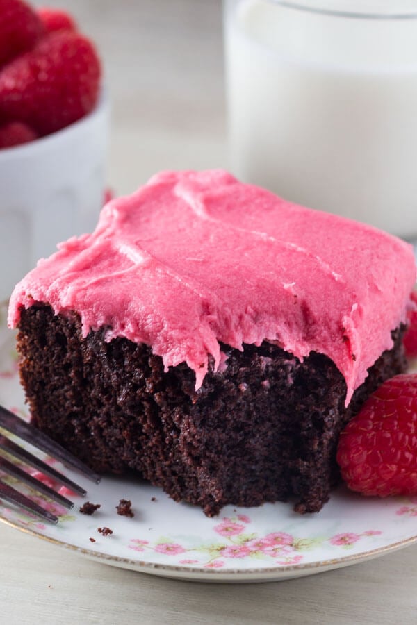 Chocolate Cake with Raspberry Frosting. This rich, super fudgy chocolate cake has a deep chocolate flavor. Then it's topped with fresh raspberry buttercream so it's perfect for Valentine's! www.justsotasty.com