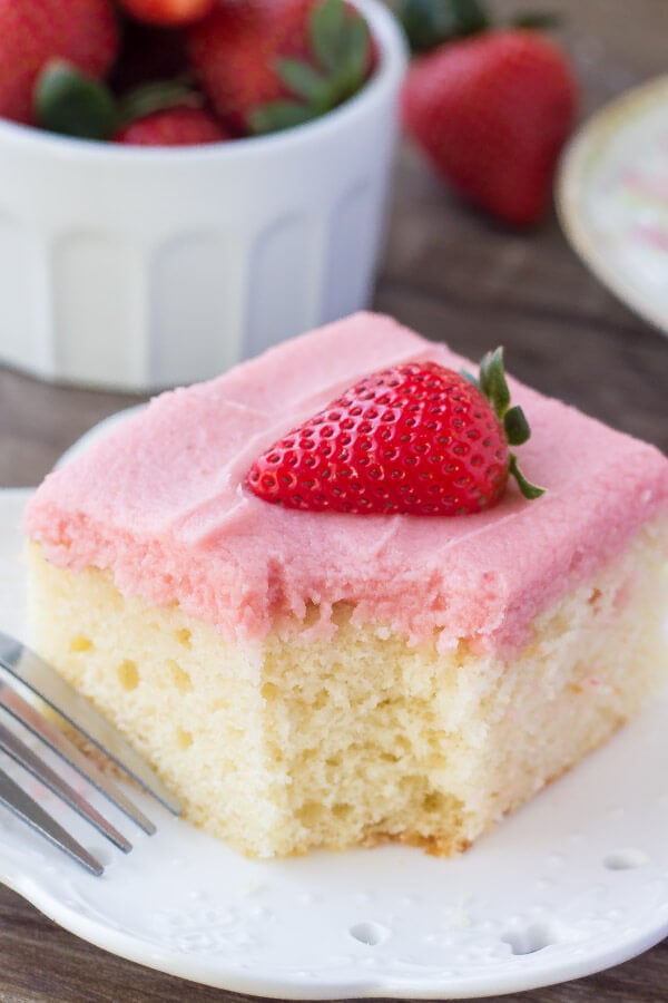 Fluffy, buttery Vanilla Cake with Strawberry Frosting. You'll love the moist, soft cake crumb & the fresh strawberry flavor of the frosting! www.justsotasty.com