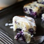 Blueberry Buttermilk Cake with Cream Cheese Glaze. Super moist & bursting with blueberries - this simple cake is perfect for summer! www.justsotasty.com