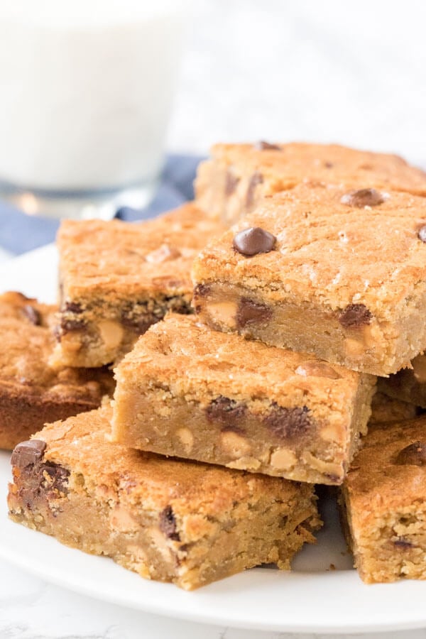 A plate of chewy peanut butter blondies - like peanut butter cookie bars that are extra chewy and a little gooey. 