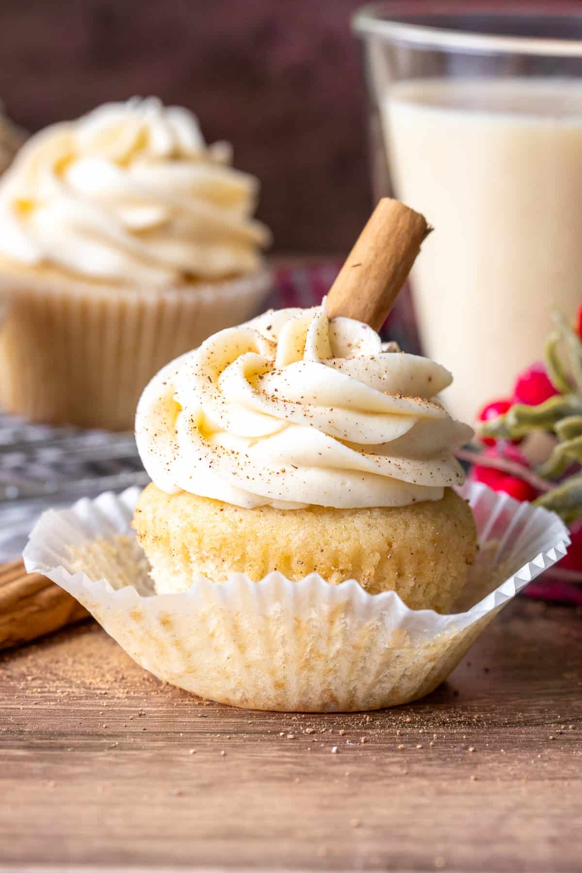 Eggnog cupcake with a glass of eggnog