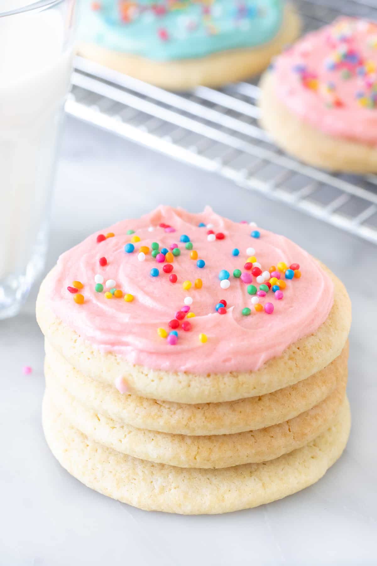 Stack of sugar cookies with a glass of milk