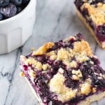 A buttery shortbread-like base, juicy blueberry filling & crumbly crumble topping - these Blueberry Crumble Bars are so easy & delicious!