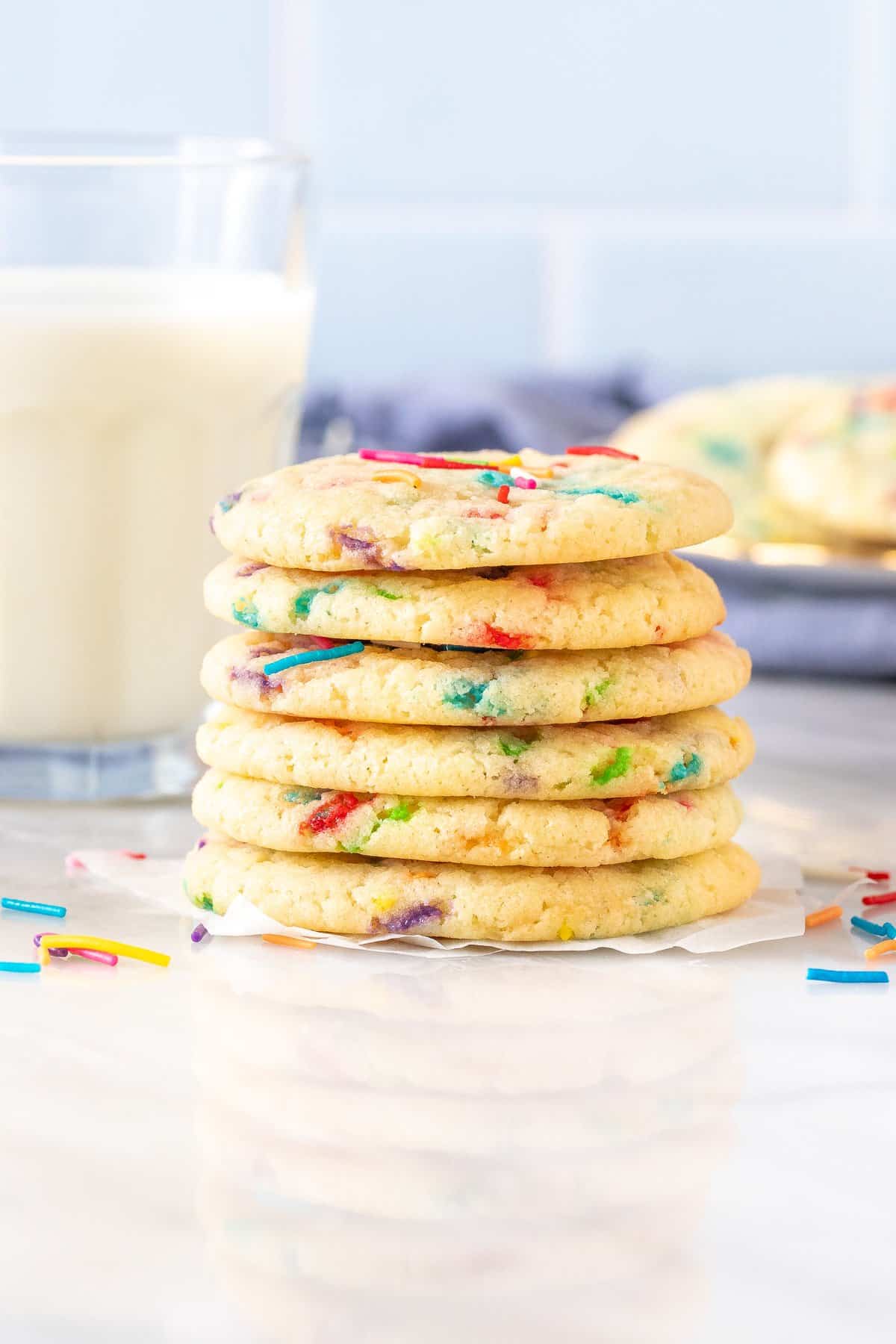 Stack of funfetti cookies with glass of milk