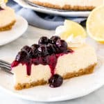 Slice of lemon cheesecake with blueberry sauce