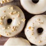 Delicious spice cake doughnuts dipped in sweet maple glaze and topped with crushed walnuts. It's like fall in maple doughnut form - and best of all, they're baked instead of fried!