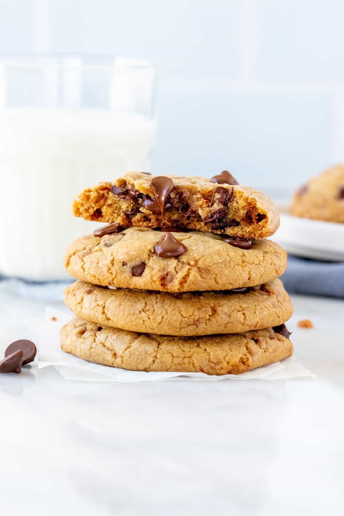 Stack of toffee chocolate chip cookies, with top cookie broken in half