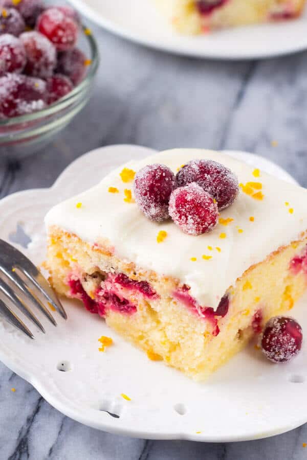 Cranberry Orange Cake with Cream Cheese Frosting. A deliciously soft Cranberry Orange Cake with Cream Cheese Frosting. Bursting with fresh oranges and dotted with tart cranberries - this is the perfect simple cake for your holiday baking! www.justsotasty.com