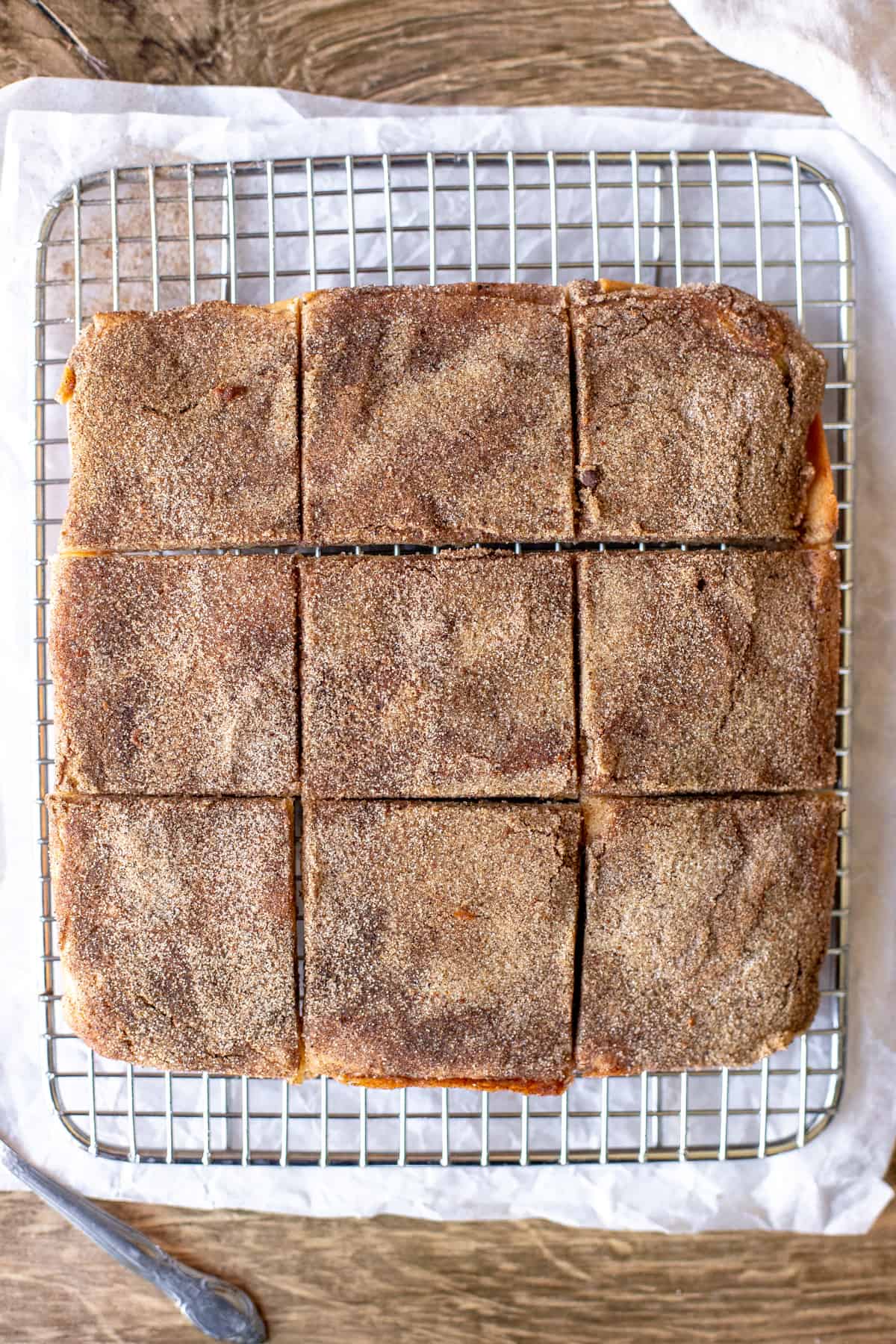 9 snickerdoodle cookie bars on a cooling rack