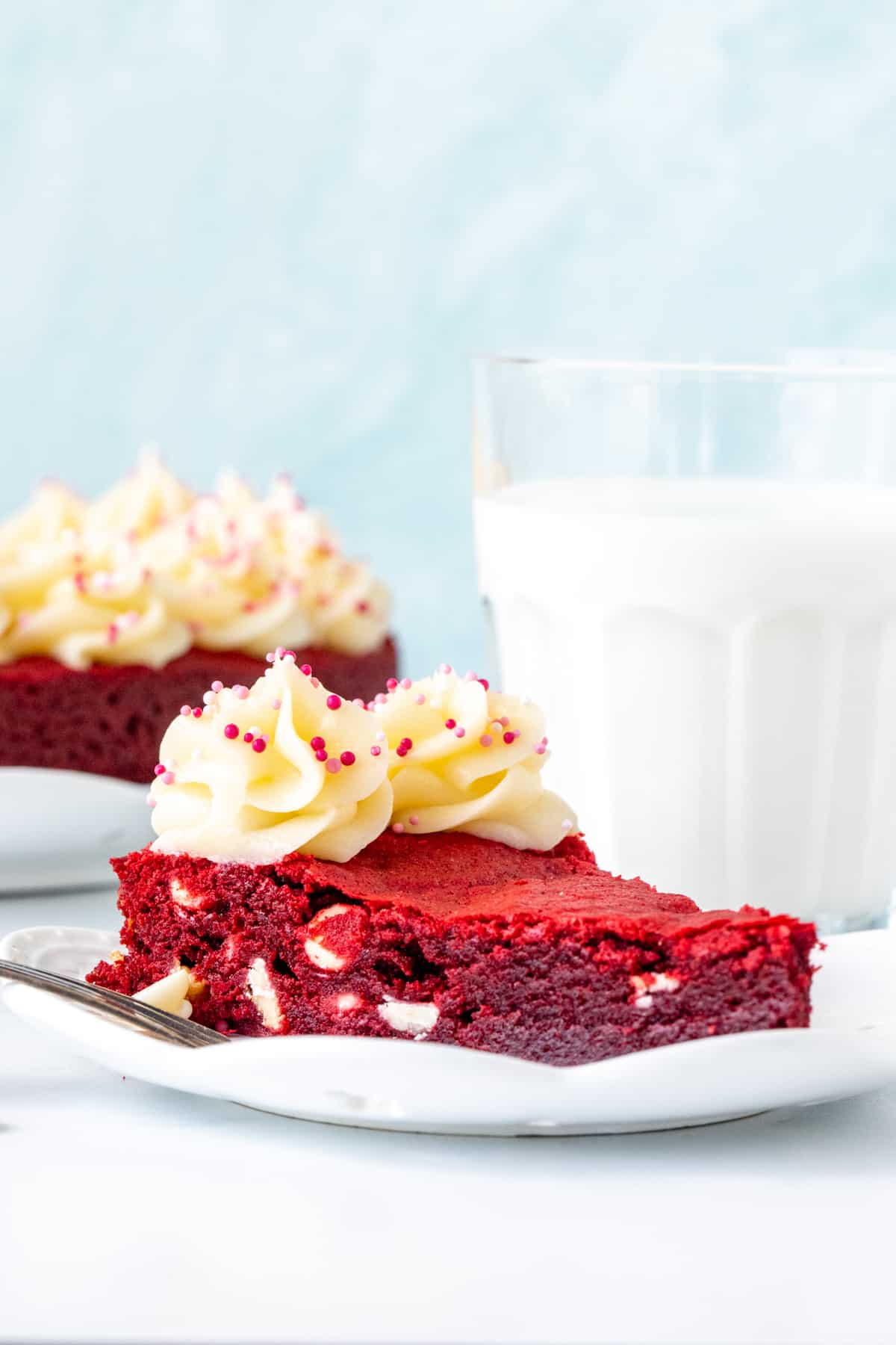 Slice of red velvet cookie cake with cream cheese frosting