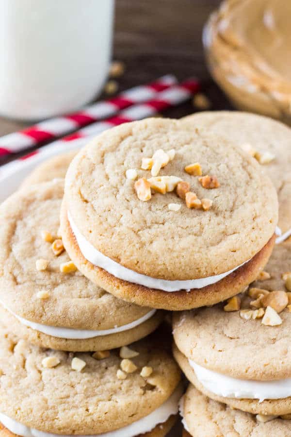 Fluffernutter Sandwich Cookies. Two soft & chewy peanut butter cookies sandwiched together with fluffy marshmallow frosting. Pure salty-sweet peanut butter bliss! www.justsotasty.com
