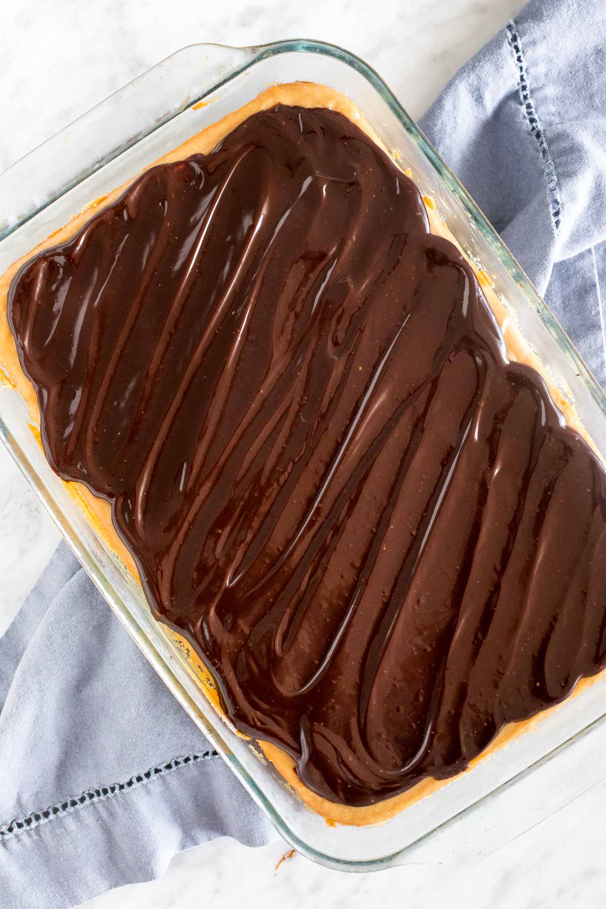 9x13 inch pan of peanut butter chocolate cheesecake. 