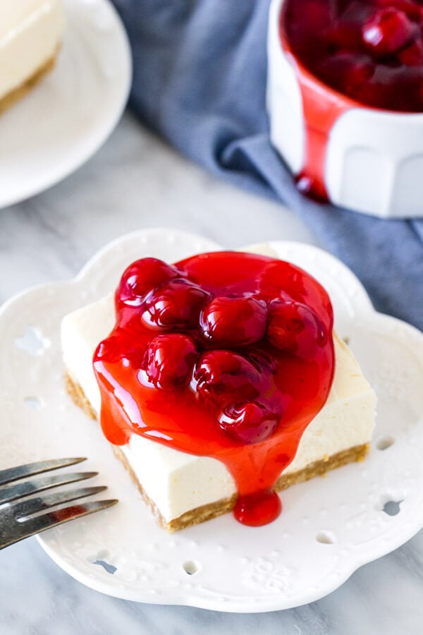 Slice of cheesecake square with cherry topping
