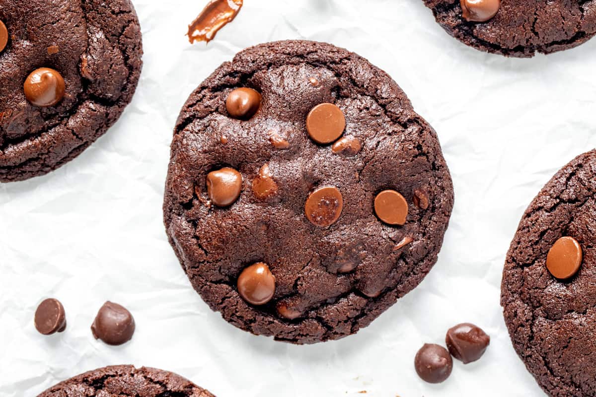 Chocolate cookies with chocolate chips on baking paper