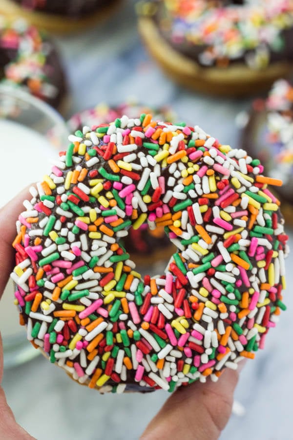 These baked vanilla doughnuts with chocolate glaze have a delicious cake doughnut texture and are ultra-moist. With a thick chocolate glaze and coated in sprinkles, they won't last long.... Plus, there's no hot oil or deep frying!