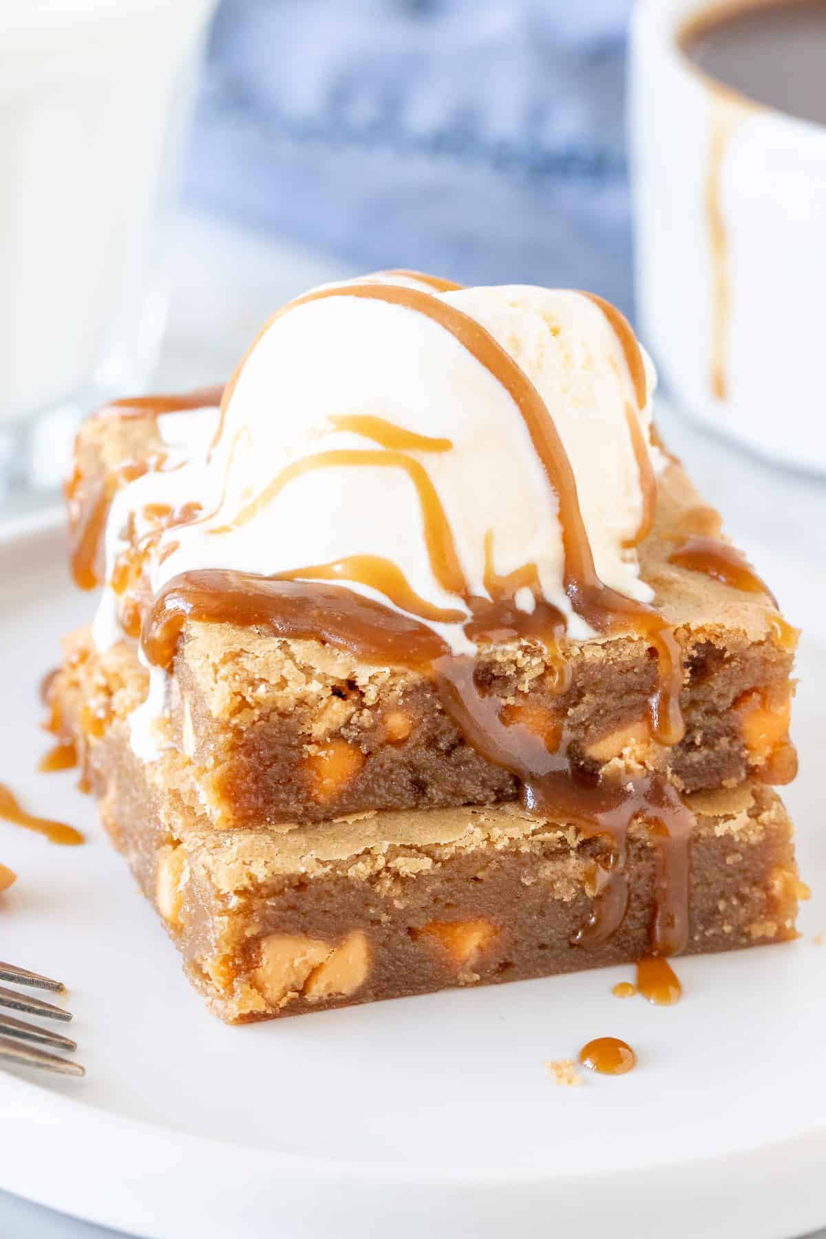 Stack of butterscotch blondies with a scoop of ice cream on top