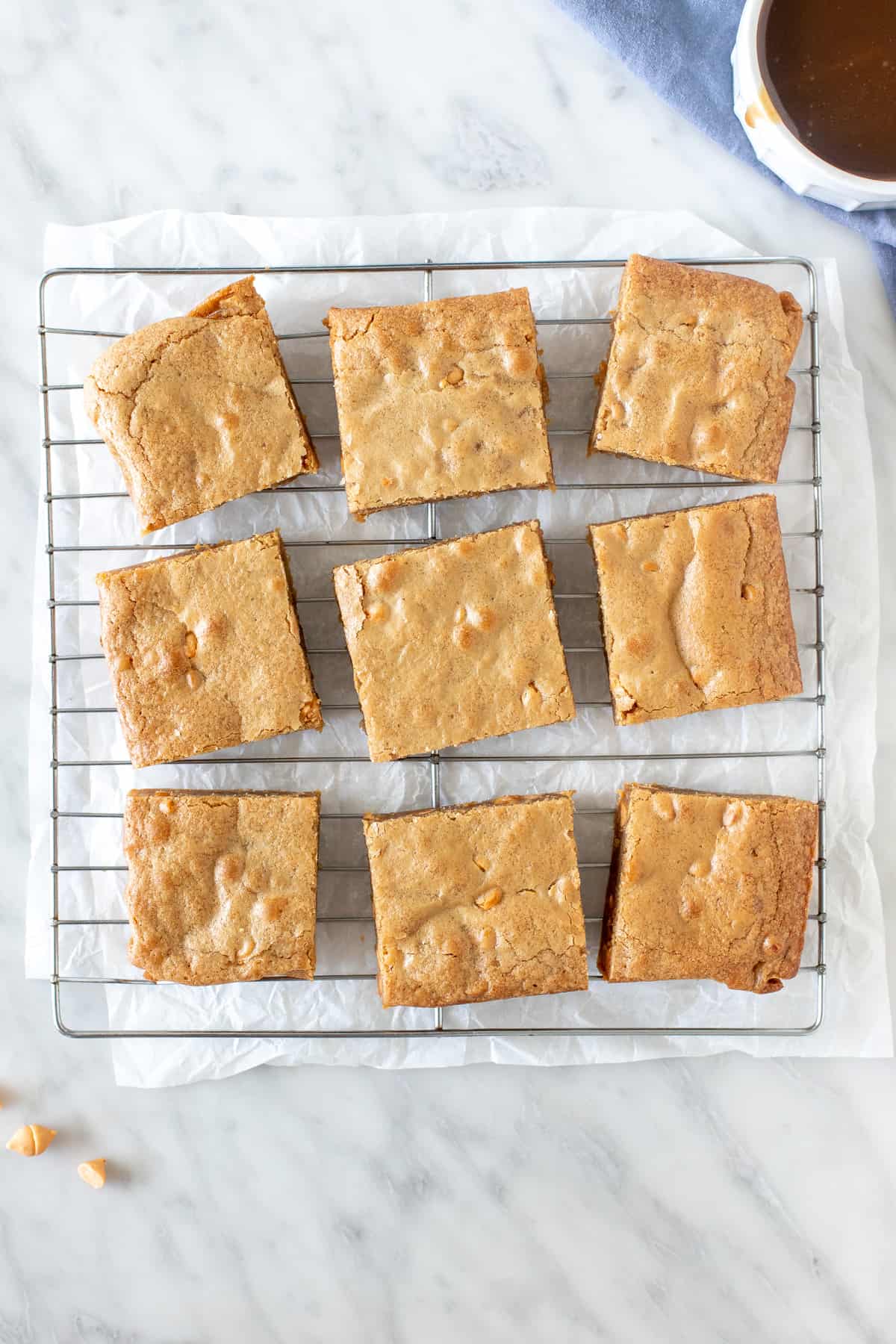 9 blondies on a cooling rack.