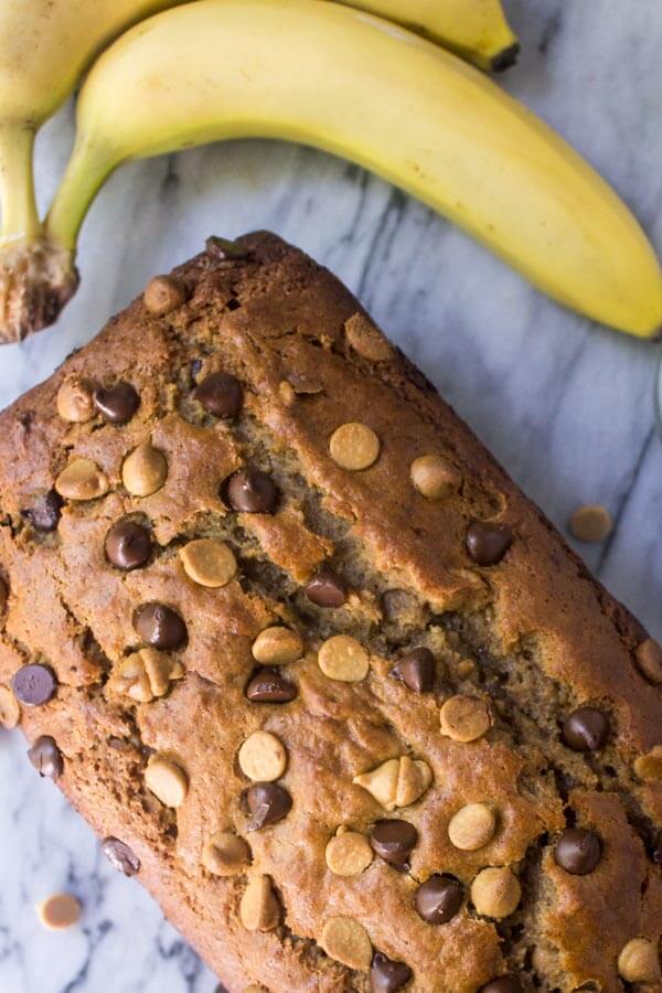 Overhead view of peanut butter banana bread loaf with chocolate chips and peanut butter chips. 