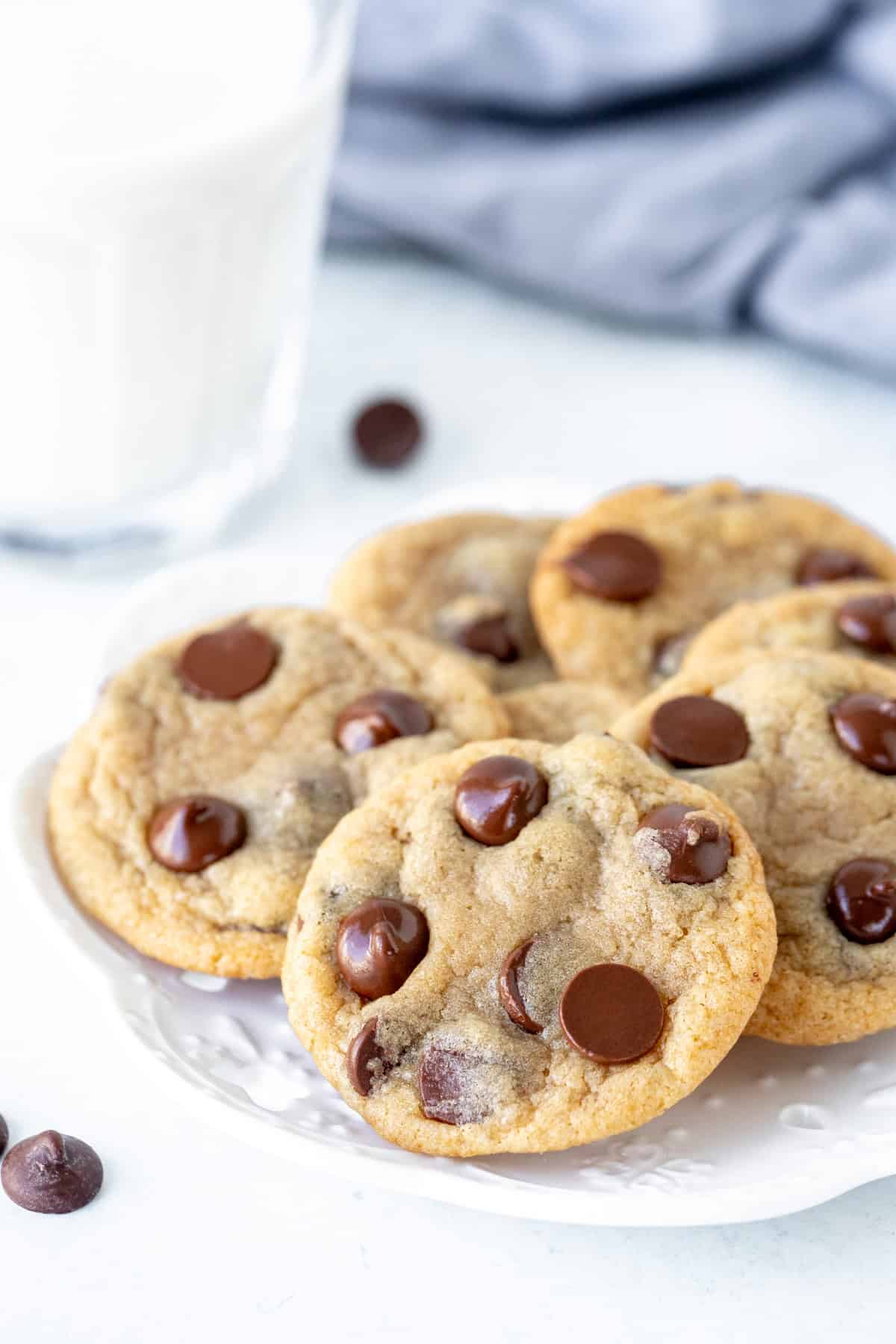 Plate of mini chocolate chip cookies with glass of milk