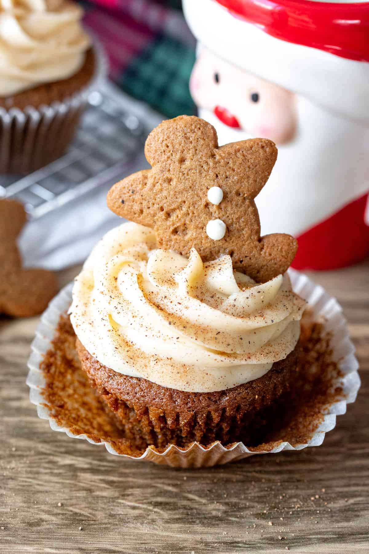 Christmas cupcake topped with gingerbread man with paper removed.