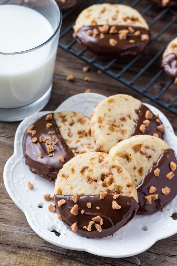Soft, buttery, melt-in-your mouth sugar cookies with golden edges. Filled with toffee pieces & dipped in chocolate - these toffee icebox cookies are just that incredible. 