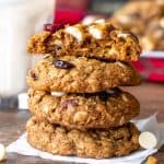 Stack of white chocolate cranberry oatmeal cookies with top cookie broken in half