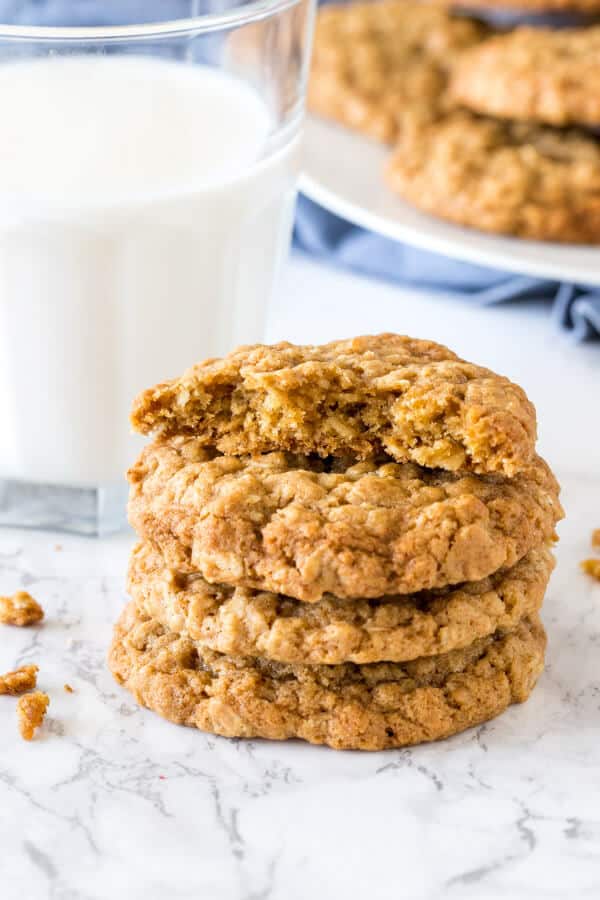 A stack of oatmeal cookies with the top cookie broken in half.