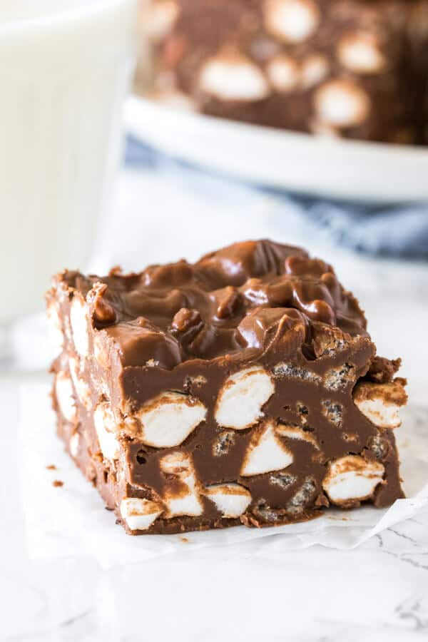 A no bake rocky road bar with a glass of milk