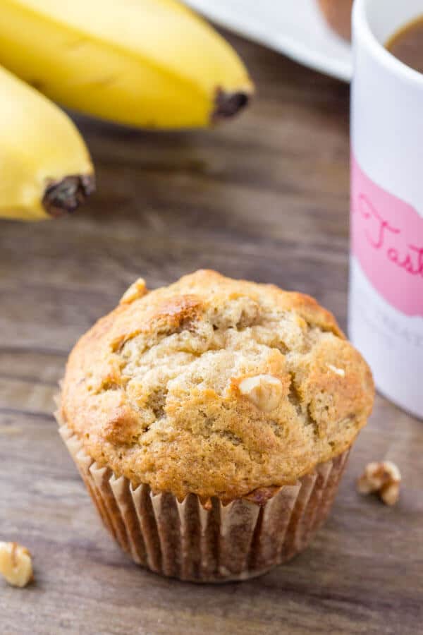 Close up shot of a moist, tender banana bread muffin with chopped walnuts. 