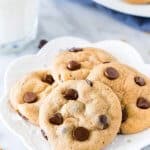 Plate of cream cheese chocolate chip cookies with a glass of milk.