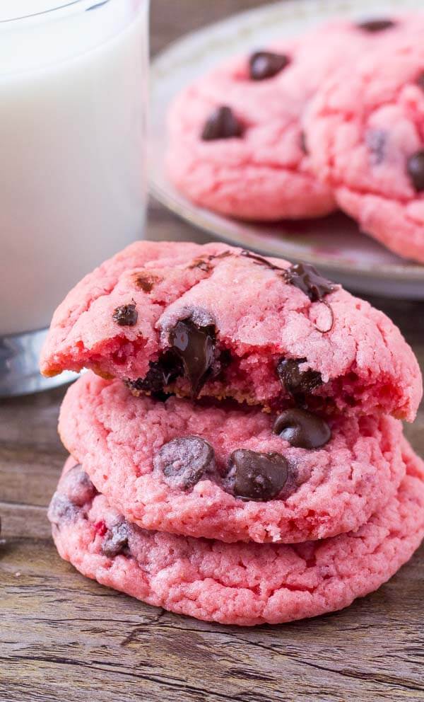 Stack of 3 strawberry cake mix cookies, with the top cookie broken in half. 