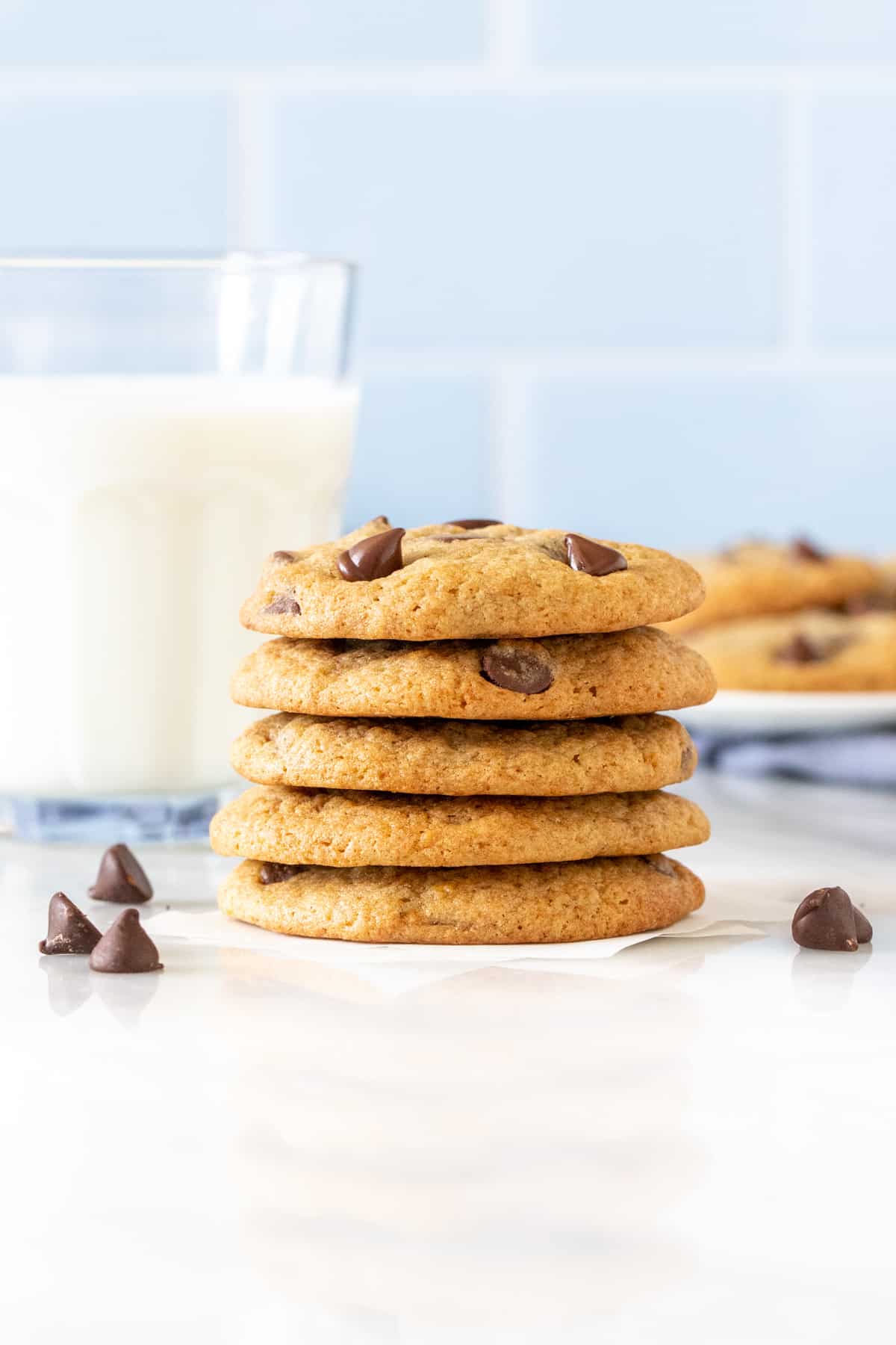 Stack of banana chocolate chip cookies with glass of milk