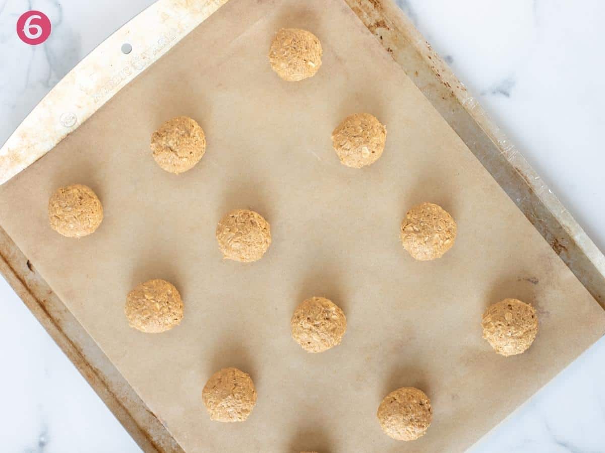 Cookie dough balls on lined cookie sheet