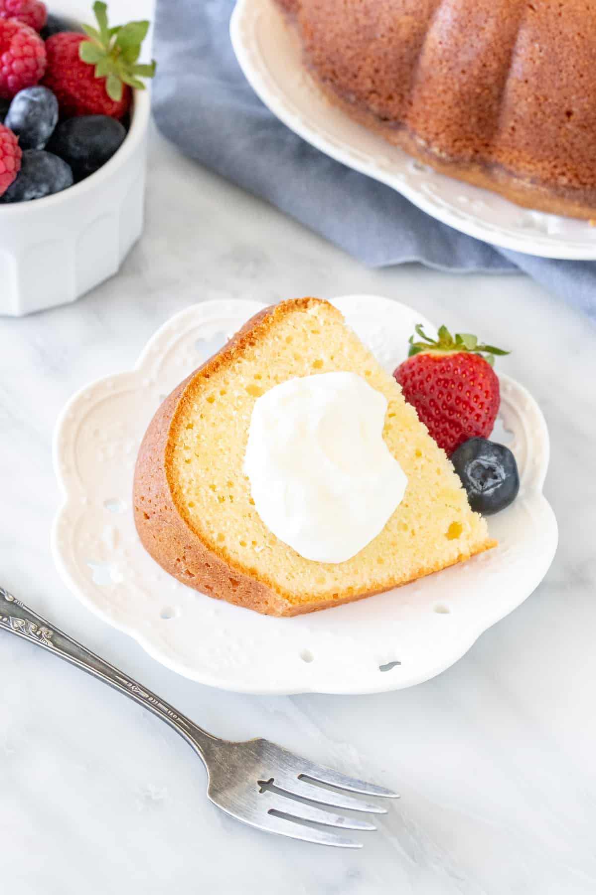 Slice of pound cake with whipped cream and berries